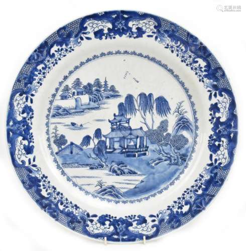 An 18th century Chinese porcelain wall charger painted with a landscape scene, diameter 46cm.