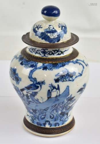 A late 19th century Chinese porcelain lidded baluster vase painted in underglaze blue with birds