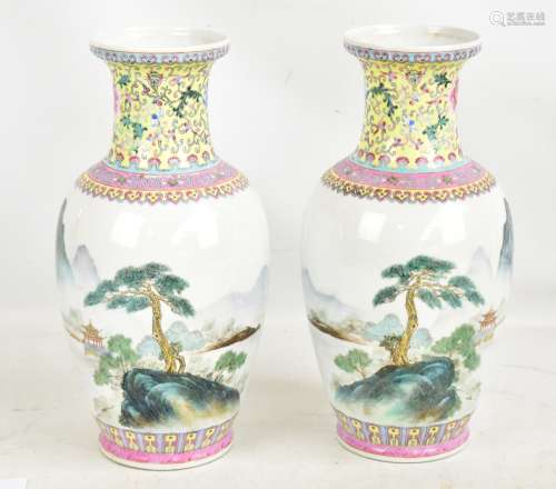 A pair of 20th century Chinese porcelain baluster vases decorated in enamels with floral scrolls and