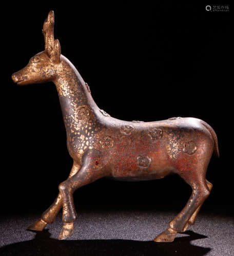 A COPPER ORNAMENT SHAPED WITH DEER