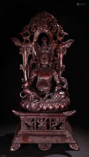 A TIBETAN CHENXIANG WOOD CARVED CAISHEN