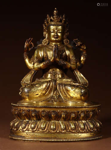 A GILT BRONZE GUANYIN BUDDHA WITH MULTIPLE HANDS
