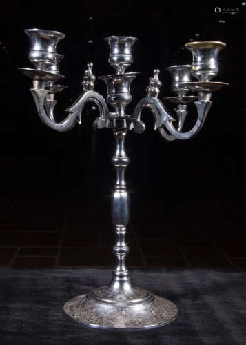 A SILVER CANDLE HOLDER CARVED WITH FLOWER