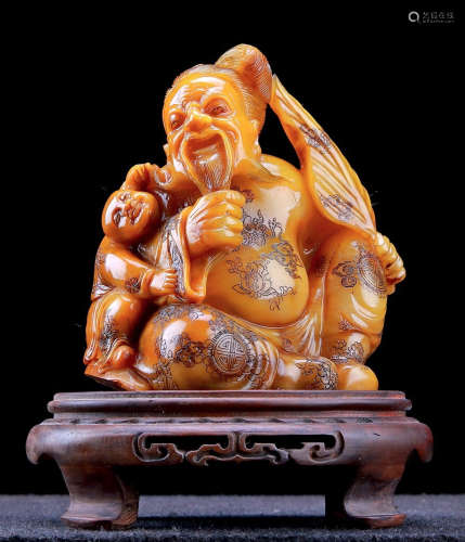 A STONE ORNAMENT CARVED WITH FIGURE