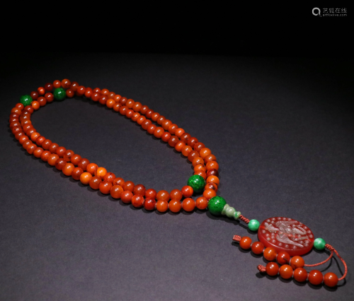AN OLD AMBER BUDDHIST NECKLACE