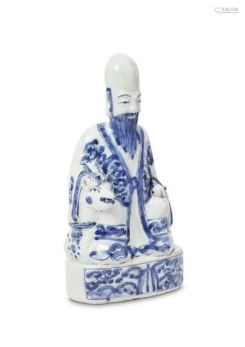 A Chinese porcelain figure of Shoulao, Ming dynasty, Wanli period, modelled seated on a recumbent