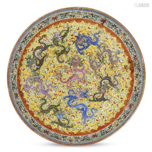 A Chinese porcelain 'nine dragons' dish, Republic period, painted in famille rose enamels with