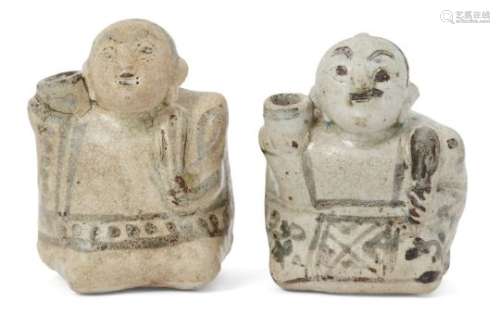 Two Annamese figural incense holders, 16th century, modelled as crouching men holding a fan in their