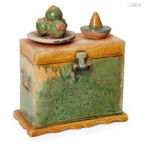 A Chinese pottery sancai-glazed miniature chest, Ming dynasty, surmounted with offerings of food,