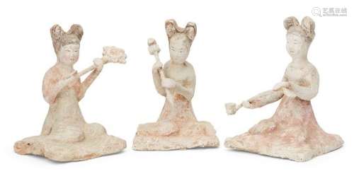 Three Chinese pottery kneeling female attendants, Tang dynasty, each with painted features and