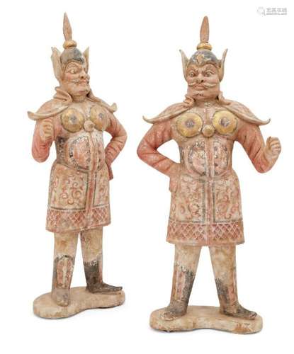 A pair of large Chinese pottery standing figures of guardians, Tang dynasty, each with detailed