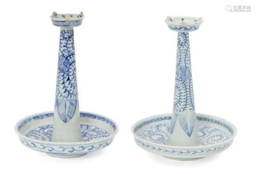 A pair of Chinese porcelain candlesticks, late 19th century, painted in underglaze blue with