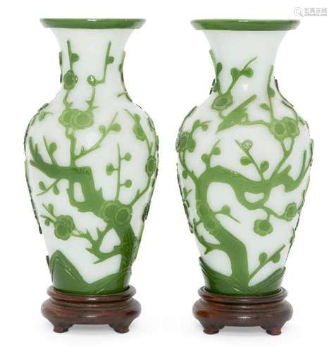 A pair of Chinese Peking green-overlay glass vases, late 19th century, carved with flowering