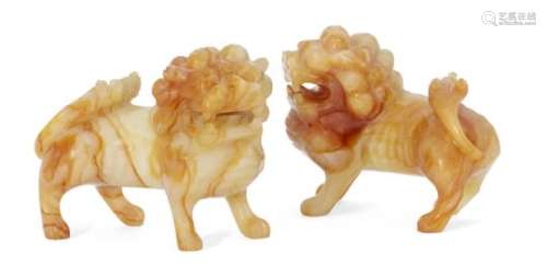 A pair of Chinese hardstone Buddhist lions, early 20th century, carved standing four square, 10cm