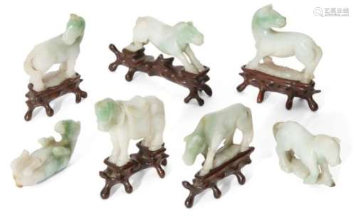 A set of seven Chinese jadeite hoses, early 20th century, carved in various poses, on fitted wood