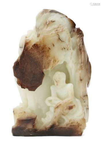 A large Chinese pale green and black jade boulder 'grotto', late Qing dynasty, carved as a luohan (