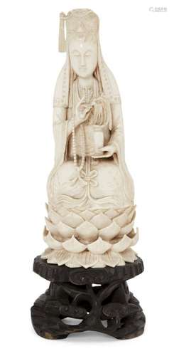 A Chinese Canton ivory figure of Guanyin, late 19th century, seated on a lotus throne holding a vase