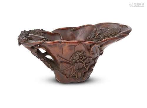 A Chinese rhinoceros horn libation cup, 17th century, finely carved as overlapping leaves, with five