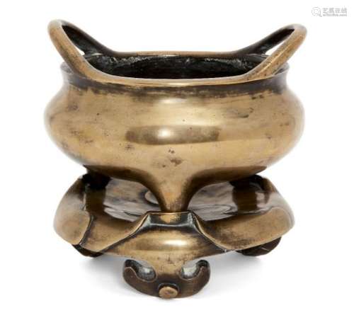 A Chinese polished bronze two-handled tripod censer and stand, 17th/18th century, of typical bombe