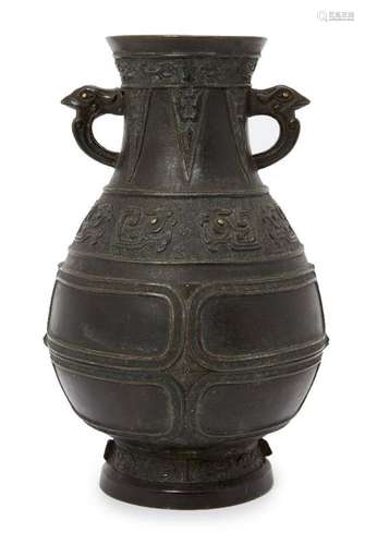 A Chinese bronze archaistic vase, hu, 17th century, cast with bird's mask handles with gold inlaid