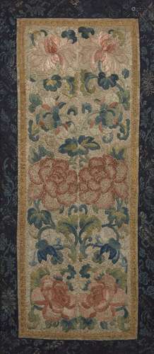 A Chinese silk embroidered panel, late 19th century, decorated with flowering peonies inside a lotus