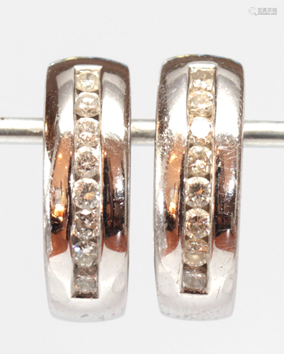 Pair of diamond, 18k white gold earrings