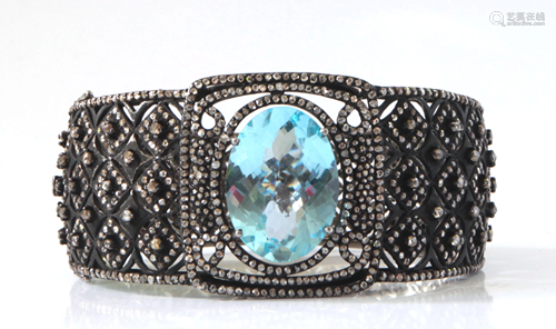 Blue topaz, diamond, blackened silver…