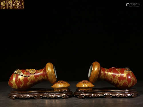 PAIR OF MONOCHROME RED GLAZED AND GILT 'BATS' FIGURES