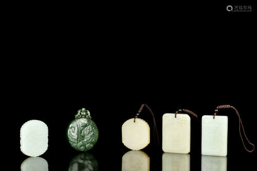 FOUR WHITE JADE P PLAQUES AND A GREEN JADE PLAQUE