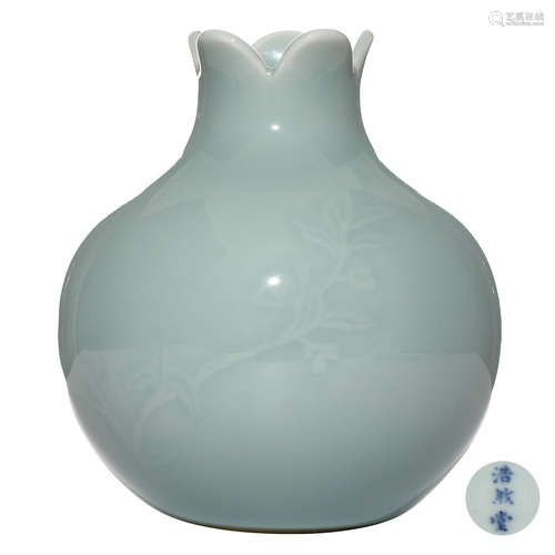 A CHINESE CARVED PEA GREEN GLAZED PORCELAIN VASE