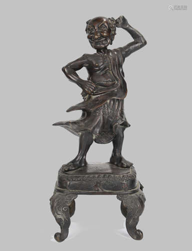 A BRONZE STANDING FIGURE ON STAND