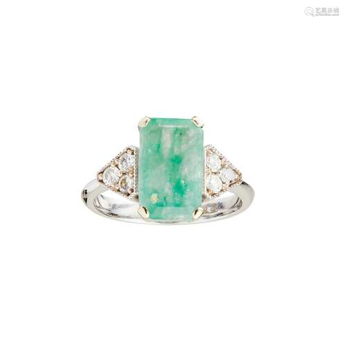 An emerald and diamond set ring