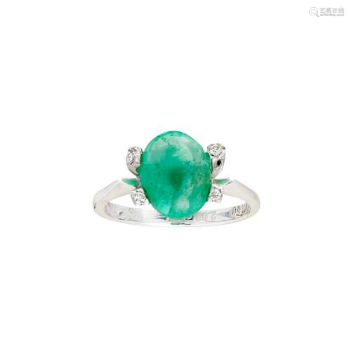 An emerald and diamond set ring