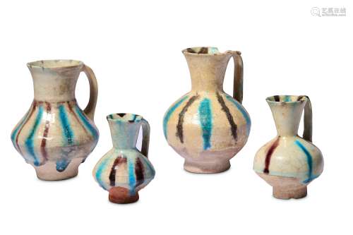 * FOUR SMALL SPLASHED KASHAN POTTERY EWERS