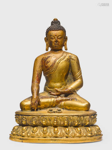 A GILT COPPER ALLOY FIGURE OF SHAKYAMUNI BUDDHA TIBET, CIRCA 15TH CENTURY