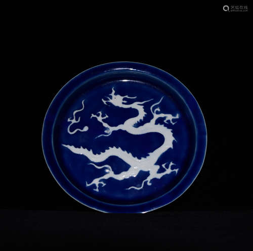 A YUAN DYNASTY PLATE DARKLY CARVED WITH DRAGON PATTERNS ON BLUE BACKGROUND