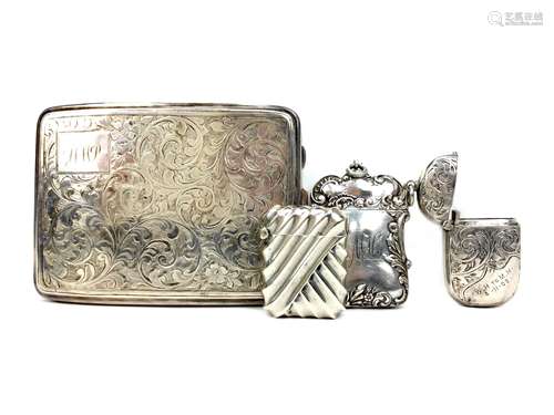 A SILVER CIGARETTE CASE AND THREE VESTA CASES