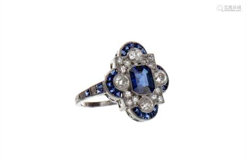 SAPPHIRE AND DIAMOND RING, the step cut sapphire surrounded by round brilliant cut diamonds and