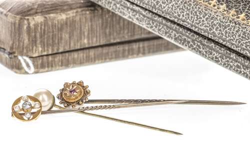 DIAMOND SET STICK PIN, with a central old cut diamond of approximately 0.05 carats flanked by four