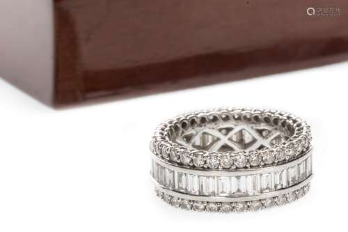 DIAMOND ETERNITY RING, set with a row of emerald cut diamonds flanked by two rows of round brilliant