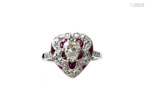 RUBY AND DIAMOND RING, set with a central pear shaped diamond, flanked by calibre cut rubied and