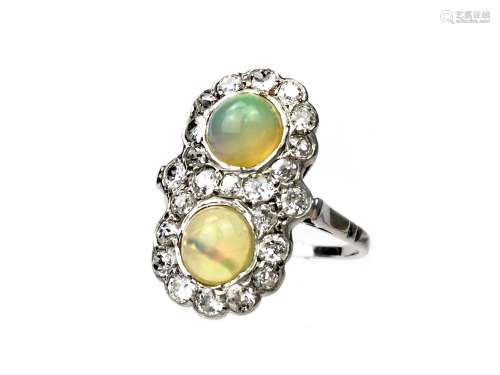 OPAL AND DIAMOND RING, set with two cabochon opals within a border of old cut diamonds, the diamonds