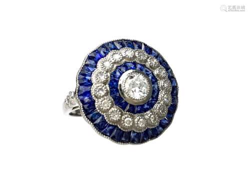 SAPPHIRE AND DIAMOND RING, the bezel 19mm in diameter, set with a central round brilliant cut