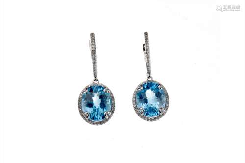 PAIR OF TOPAZ AND DIAMOND EARRINGS, each set with an oval faceted topaz within a halo of round