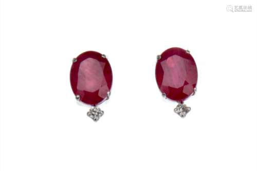 PAIR OF TREATED RUBY AND DIAMOND EARRINGS, each set with an oval faceted treated ruby and a round