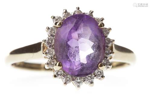 AMETHYST AND DIAMOND CLUSTER RING, the oval amethyst 10mm long, within a diamond halo, the