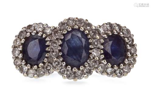 BLUE GEM SET AND DIAMOND CLUSTER RING, the three oval blue gems within a round brilliant cut diamond