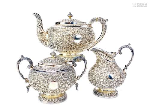 AN INDIAN WHITE METAL THREE PIECE TEA SERVICE