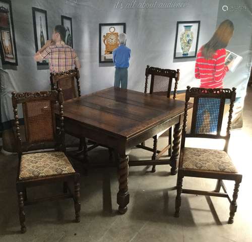 AN OAK DRAW LEAF DINING TABLE AND FOUR CHAIRS