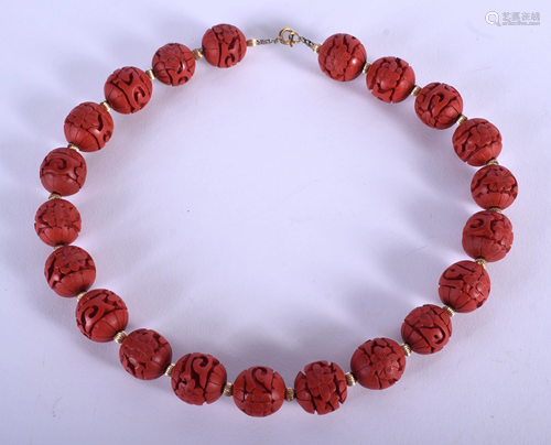 A CHINESE RED BEAD NECKLACE. 30 cm long.